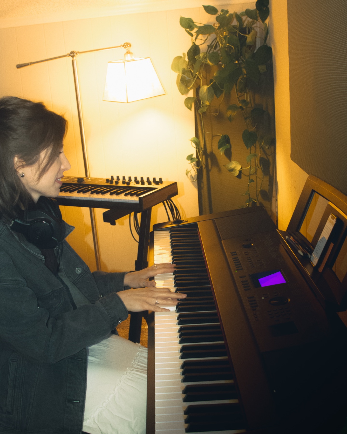 An artist playing keys in the studio