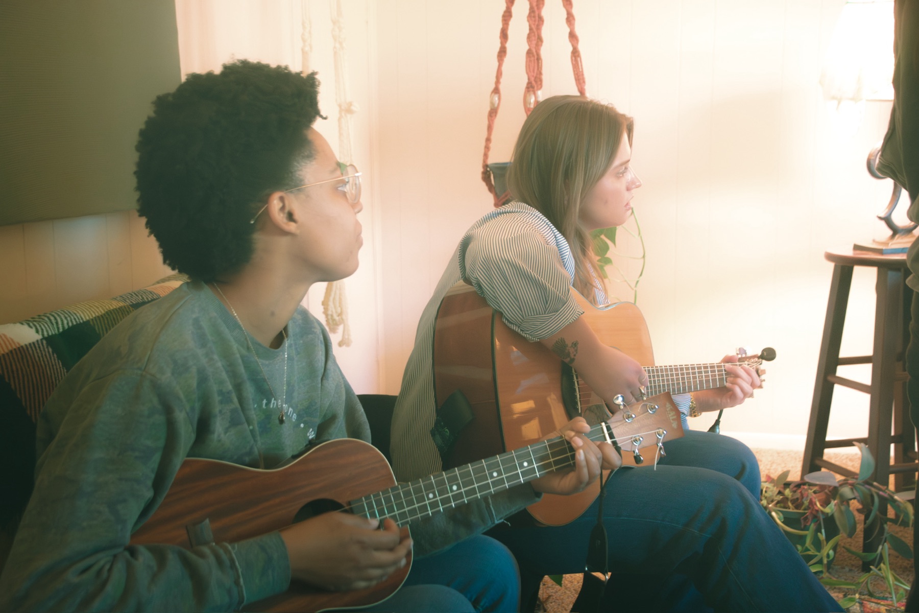 Artists playing ukulele and guitar in the studio